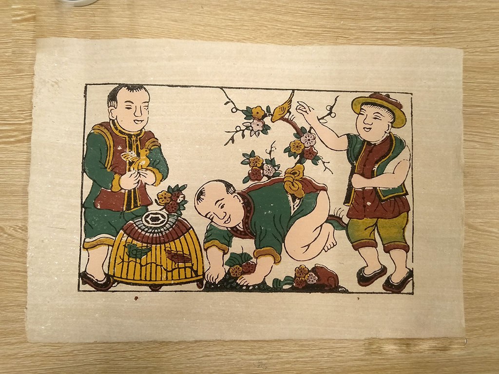 Đông Hồ print of three children with a birdcage under a flowering branch